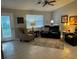Cozy living room with neutral decor, comfortable seating and natural lighting from a window and glass door at 529 Del Mar Dr, Lady Lake, FL 32159