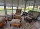 A sunroom offers a relaxing atmosphere with wicker seating, natural light, and scenic views at 529 Del Mar Dr, Lady Lake, FL 32159