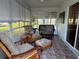 A cozy sunroom with wicker seating, neutral decor, and ample natural lighting, perfect for relaxation at 529 Del Mar Dr, Lady Lake, FL 32159