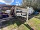 Exterior of a home with a small porch, white fence and yard at 5809 County Road 547 N, Davenport, FL 33837