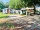 Property with ample parking space in a yard with trees, shrubs, and a clearly visible house number at 5809 County Road 547 N, Davenport, FL 33837
