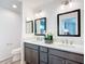 Elegant bathroom with dual sinks, framed mirrors, quartz countertop, and modern fixtures at 6633 Holovak Ter, The Villages, FL 34762
