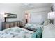 Bright bedroom featuring twin beds, ceiling fan, closet, and neutral decor at 6633 Holovak Ter, The Villages, FL 34762