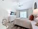 Cozy bedroom features a comfortable bed, white furniture, and a large window for natural light at 6633 Holovak Ter, The Villages, FL 34762