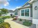 Charming home exterior with manicured landscaping, stone accents, and symmetrical design at 6633 Holovak Ter, The Villages, FL 34762