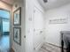Hallway with closet, laundry signage, wall art and modern gray flooring at 6633 Holovak Ter, The Villages, FL 34762