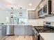 Modern kitchen featuring stainless steel appliances, light gray cabinets, and white countertops at 6633 Holovak Ter, The Villages, FL 34762
