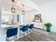 Open kitchen featuring a breakfast bar with seating, modern pendant lights, and white cabinetry at 6633 Holovak Ter, The Villages, FL 34762