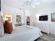 Spacious main bedroom with white furniture, ensuite bathroom access, and a tranquil atmosphere at 6633 Holovak Ter, The Villages, FL 34762