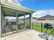 Screened in patio with backyard access; includes a grill, seating, and a ceiling fan at 6633 Holovak Ter, The Villages, FL 34762