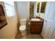 Cozy bathroom featuring a wood cabinet, toilet, decor, and vanity with sink at 664 Mission Hills Trl, The Villages, FL 32162