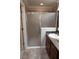 Bathroom featuring modern shower with glass door, tiled walls and vanity at 664 Mission Hills Trl, The Villages, FL 32162