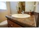 Well-lit bathroom with a vanity, framed mirror, decor and wood cabinet at 664 Mission Hills Trl, The Villages, FL 32162