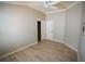 Bright bedroom with tray ceilings, closet, laminate flooring and neutral paint at 664 Mission Hills Trl, The Villages, FL 32162