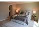 Comfortable bedroom with stylish decor, wood floors and a neutral color palette at 664 Mission Hills Trl, The Villages, FL 32162