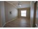 Bright bedroom with tray ceilings, laminate flooring, neutral paint and a window at 664 Mission Hills Trl, The Villages, FL 32162