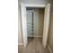 Spacious closet with wooden laminate flooring, shelving, and bi-fold doors at 664 Mission Hills Trl, The Villages, FL 32162