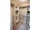 Walk in closet with custom shelving, drawers, and ample storage for an organized wardrobe at 664 Mission Hills Trl, The Villages, FL 32162