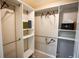 Walk in closet with custom shelving, drawers, and ample storage for an organized wardrobe at 664 Mission Hills Trl, The Villages, FL 32162