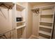 Well-organized walk-in closet with ample shelving and hanging space for optimal storage at 664 Mission Hills Trl, The Villages, FL 32162