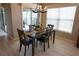 Comfortable dining space with modern chandelier and a view to the patio at 664 Mission Hills Trl, The Villages, FL 32162