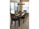Dining area featuring a chandelier, wood table and chairs, and views of the backyard at 664 Mission Hills Trl, The Villages, FL 32162