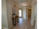 Inviting foyer with decorative table and art leading to other rooms of the home at 664 Mission Hills Trl, The Villages, FL 32162