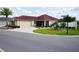 Beautiful single-story home with a lush front lawn, mature landscaping, and a spacious driveway at 664 Mission Hills Trl, The Villages, FL 32162