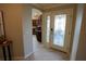 Inviting home foyer with decorative glass front door and a view into the kitchen at 664 Mission Hills Trl, The Villages, FL 32162