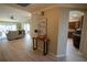 Spacious home entryway with hardwood floors and a view into the kitchen and living room at 664 Mission Hills Trl, The Villages, FL 32162