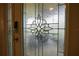 Elegant front door featuring decorative glass panels and a modern smart lock at 664 Mission Hills Trl, The Villages, FL 32162