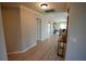 Bright and airy hallway with wood floors leading to the living room and bedrooms at 664 Mission Hills Trl, The Villages, FL 32162