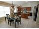 Eat-in kitchen with wooden cabinets, stainless steel appliances, and island at 664 Mission Hills Trl, The Villages, FL 32162