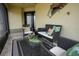 Cozy screened-in porch featuring outdoor seating, a glass coffee table, and tile flooring at 664 Mission Hills Trl, The Villages, FL 32162