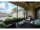 Inviting outdoor screened patio with comfortable seating and a view of the landscaped yard at 664 Mission Hills Trl, The Villages, FL 32162