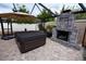 Hot tub and stone fireplace on the screened patio, perfect for outdoor entertaining at 664 Mission Hills Trl, The Villages, FL 32162