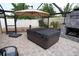 View of covered hot tub and stone fireplace in the screened-in outdoor patio at 664 Mission Hills Trl, The Villages, FL 32162