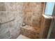 Tiled shower features a built-in seat and a sleek, modern shower-head and glass door at 664 Mission Hills Trl, The Villages, FL 32162