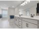 Bright bathroom with double vanity, stylish lighting, and white cabinets for storage at 678 Blackstone St, Minneola, FL 34715