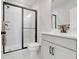 Modern bathroom with a glass shower, white vanity, and sleek fixtures at 678 Blackstone St, Minneola, FL 34715