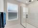 Modern bathroom showcasing glass shower with a rainfall shower head and sleek fixtures at 678 Blackstone St, Minneola, FL 34715