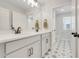 Bathroom featuring a double vanity, modern faucet, and a stylish patterned floor at 678 Blackstone St, Minneola, FL 34715