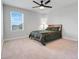 Bedroom with window view, neutral carpet, and a ceiling fan at 678 Blackstone St, Minneola, FL 34715