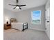 Bedroom featuring a twin bed, wood nightstand, and a window at 678 Blackstone St, Minneola, FL 34715