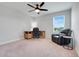 Bedroom featuring a desk, wood floors, a ceiling fan, and a black reclining chair near the window at 678 Blackstone St, Minneola, FL 34715