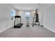 Versatile bonus room with gym equipment, soft carpet, and abundant light from a window at 678 Blackstone St, Minneola, FL 34715