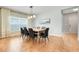 This dining room features hardwood floors, a long wood table, and black dining chairs at 678 Blackstone St, Minneola, FL 34715