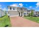 Charming two-story home with brick driveway, attached two-car garage and manicured front yard at 678 Blackstone St, Minneola, FL 34715