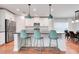 Bright kitchen with stainless steel appliances, modern pendants, and beautiful hardwood flooring at 678 Blackstone St, Minneola, FL 34715