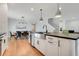 Modern kitchen featuring white cabinets, stainless steel appliances, and a central island; the dining room is in the background at 678 Blackstone St, Minneola, FL 34715